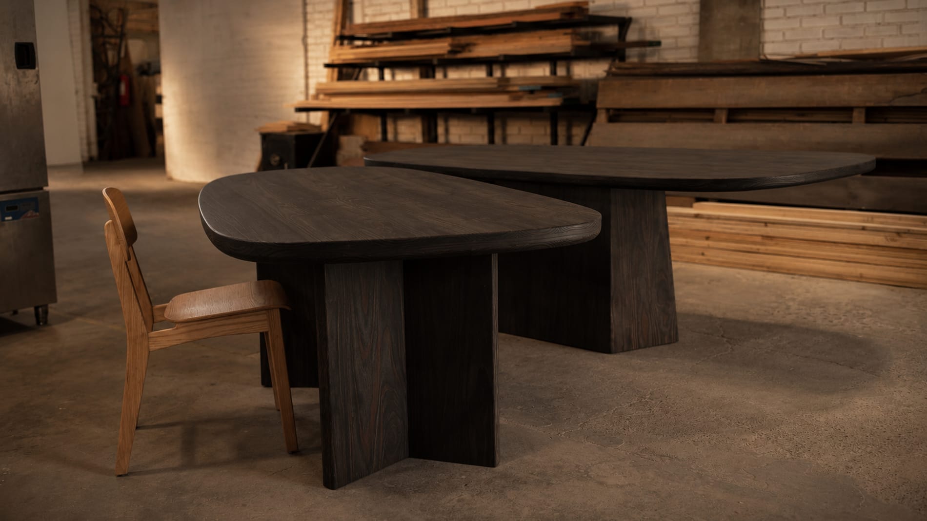 Dos mesas de forma orgánica en madera, en el taller